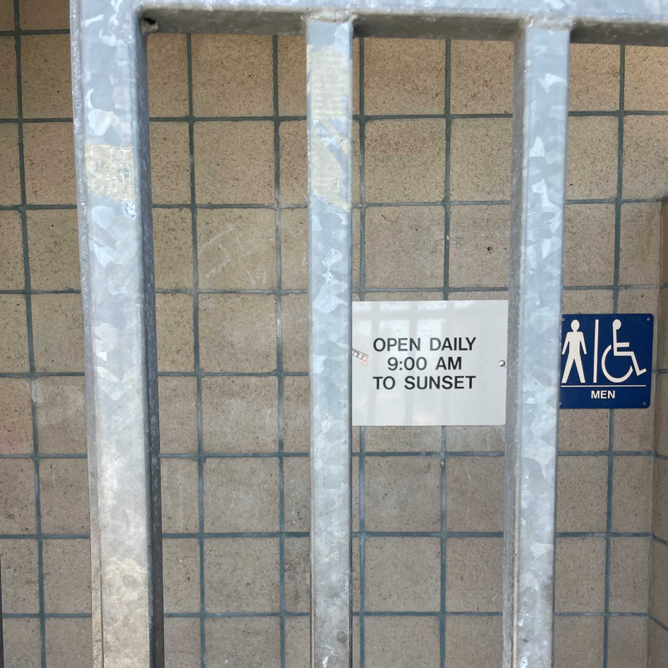 A closed bathroom with bars securing the entrance.